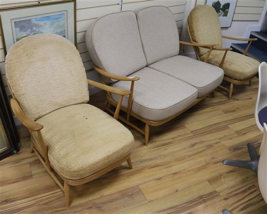 An Ercol light elm two seater and armchairs, all with cushion seats and backs (3), sofa 135cm wide